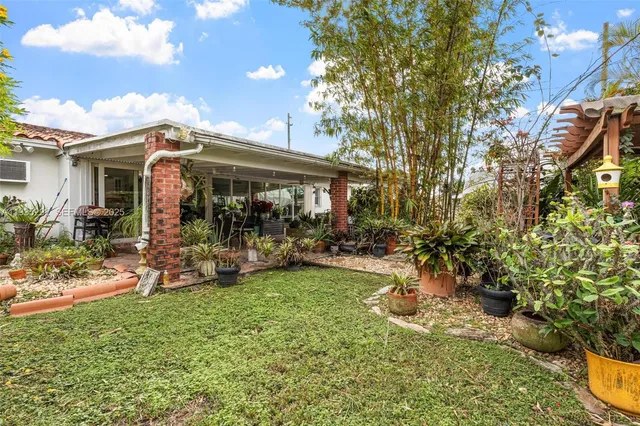 a view of a house with backyard porch and sitting area