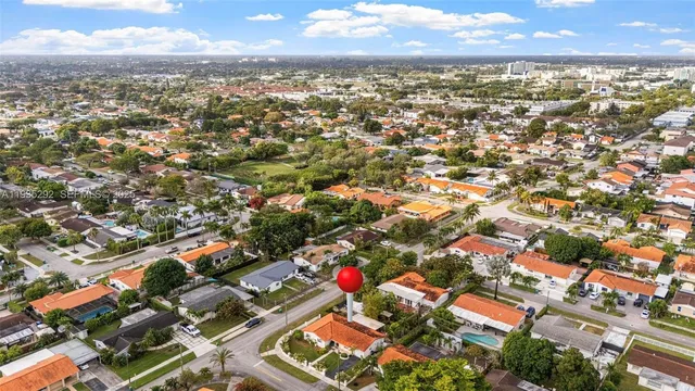 an aerial view of residential building with parking