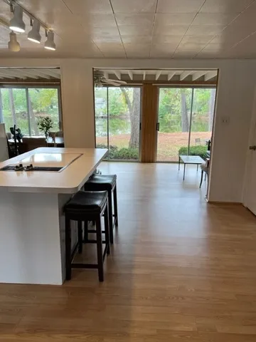 a dining room with furniture and wooden floor