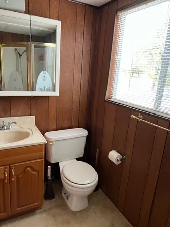 a bathroom with a toilet a sink and a window