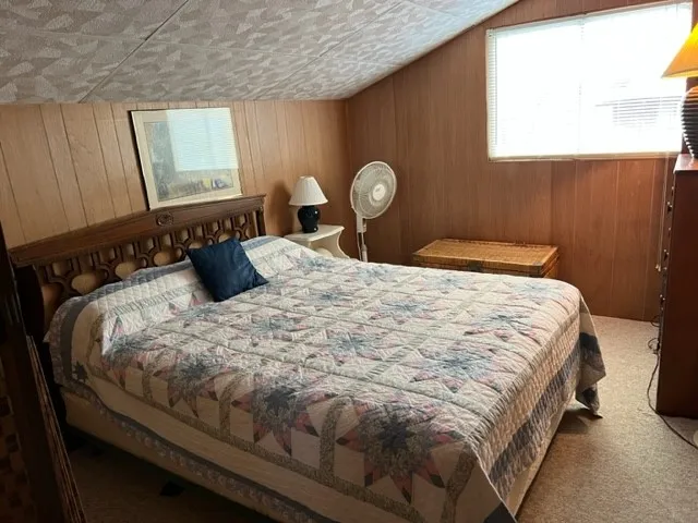 a bed sitting in a bedroom next to a window