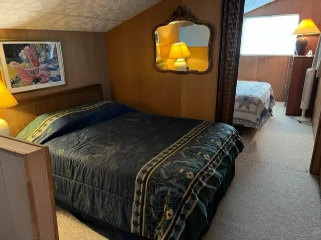 a bed sitting in a bedroom next to a lamp