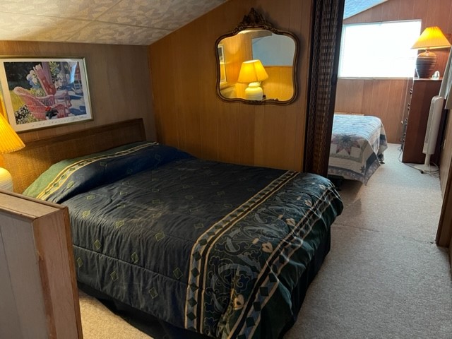 29 Thomas Lake Road Huntsville, TX 77320 - Photo 22 of 43 a bed sitting in a bedroom next to a lamp