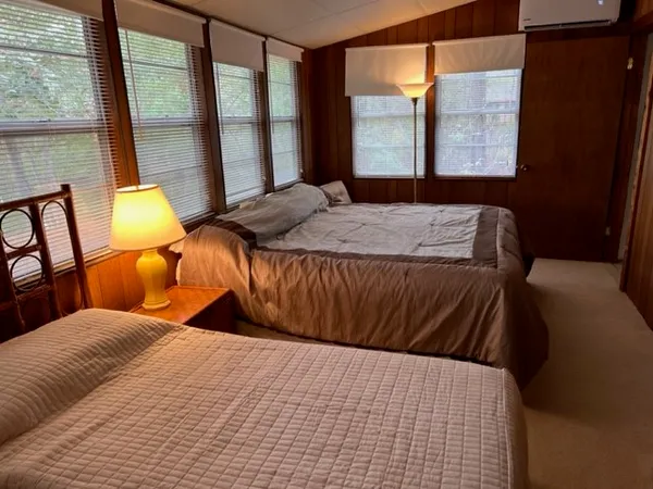 a bedroom with a bed and a large window