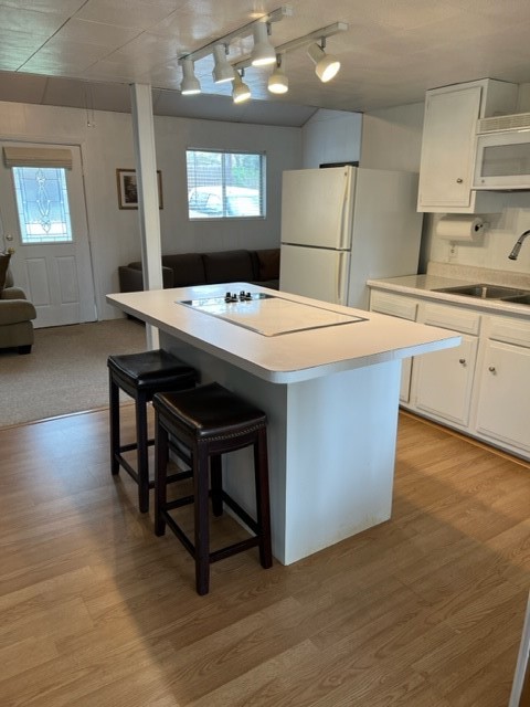 29 Thomas Lake Road Huntsville, TX 77320 - Photo 26 of 43 a kitchen with stainless steel appliances kitchen island a table chairs in it and a wooden floors
