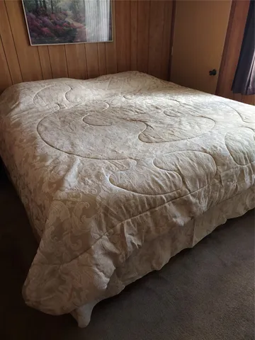 a bedroom with a bed and a cabinets