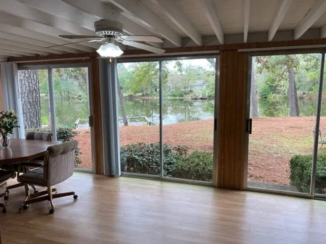 a view of a room with furniture and wooden floor