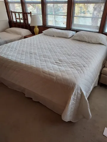 a bedroom with bed and window