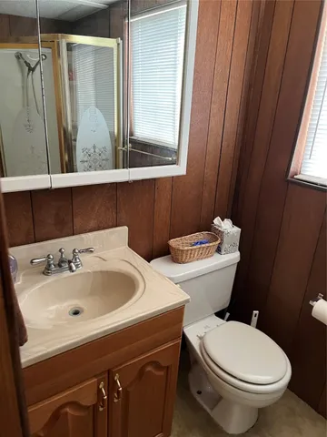 a bathroom with a sink and mirror with toilet
