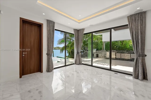 a view of an empty room with windows and a balcony