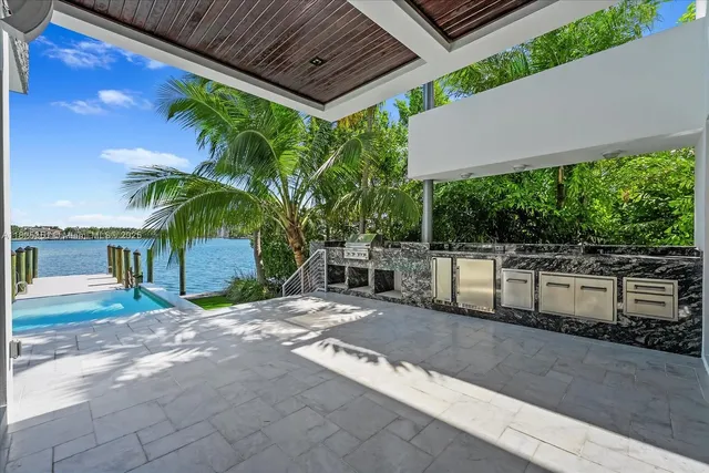 a view of a house with a patio and a yard