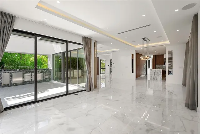 a view of a hall with floor to ceiling windows