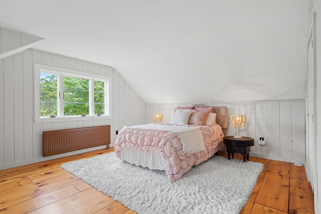 232 Sudbury Road Concord, MA 01742 - Photo 26 of 35 a bedroom with a bed and wooden floor