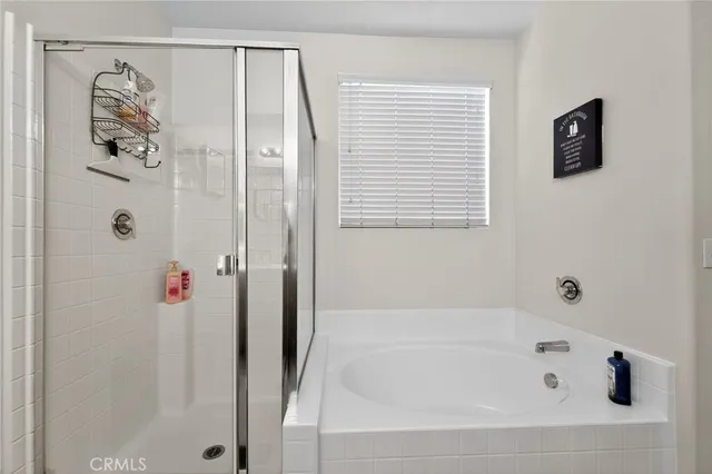 a bathroom with a bathtub and a shower