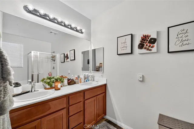 a bathroom with a sink mirror and vanity