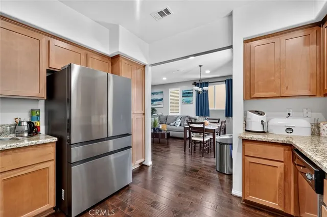 a kitchen with stainless steel appliances granite countertop a refrigerator stove microwave and sink