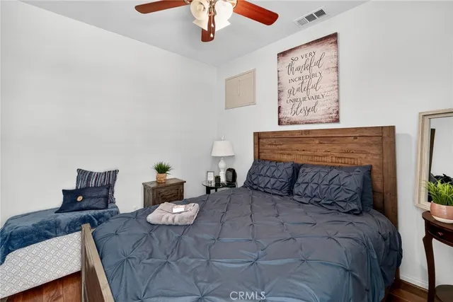 a bedroom with a bed and wooden floor
