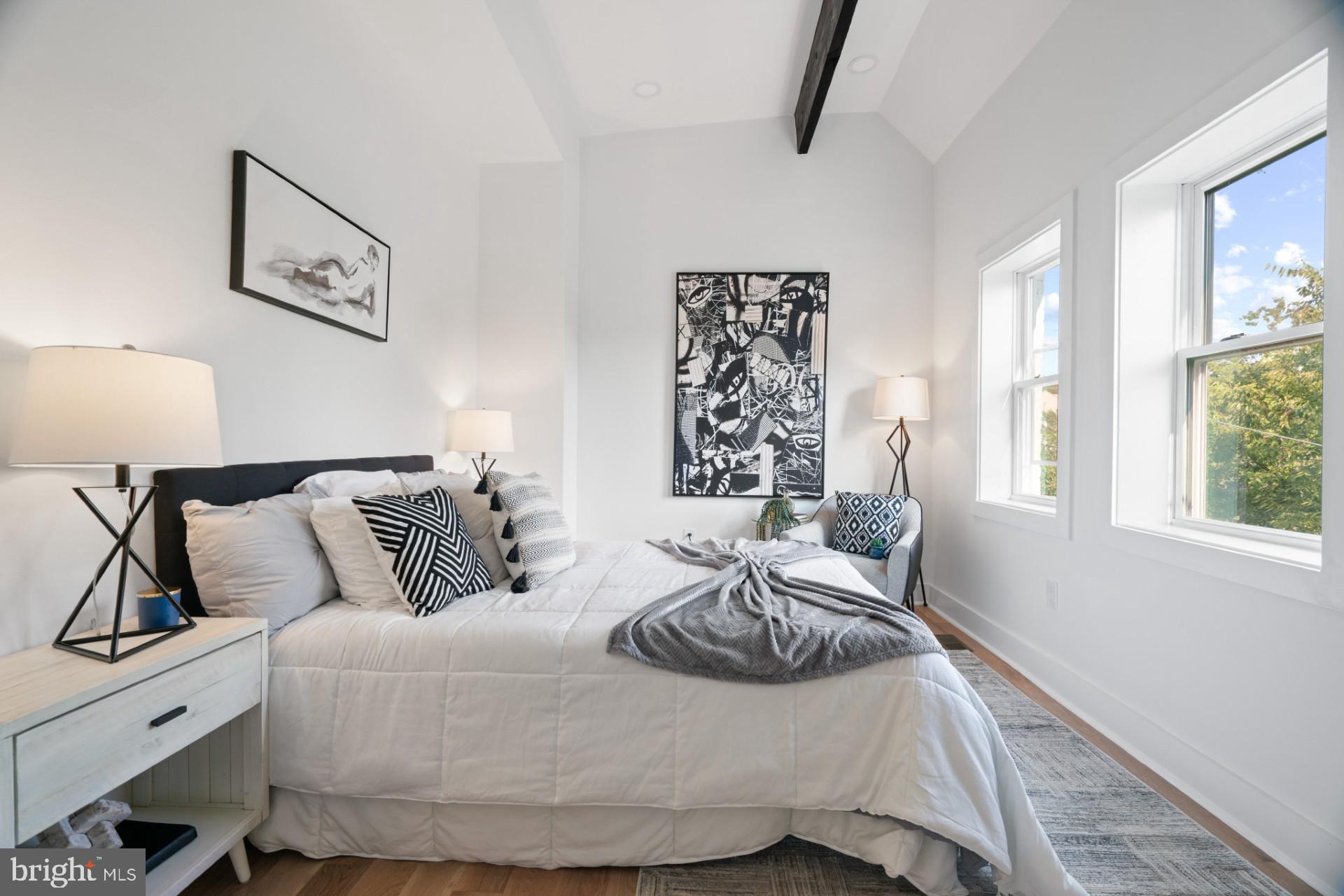 445 Decatur Street Northwest Washington, DC 20011 - Photo 11 of 28 a bedroom with a bed and wooden floor