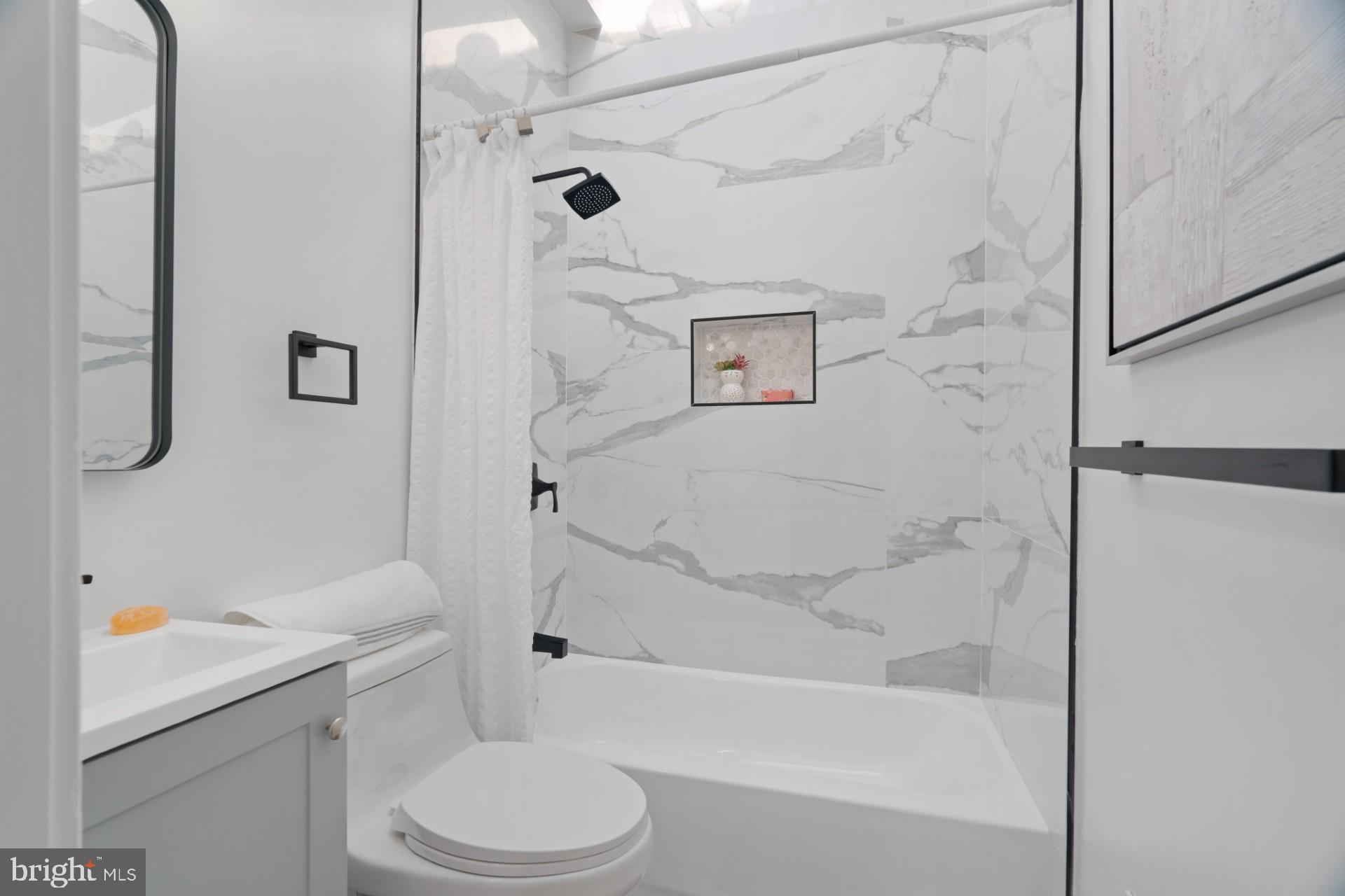 445 Decatur Street Northwest Washington, DC 20011 - Photo 12 of 28 a bathroom with a sink toilet and shower