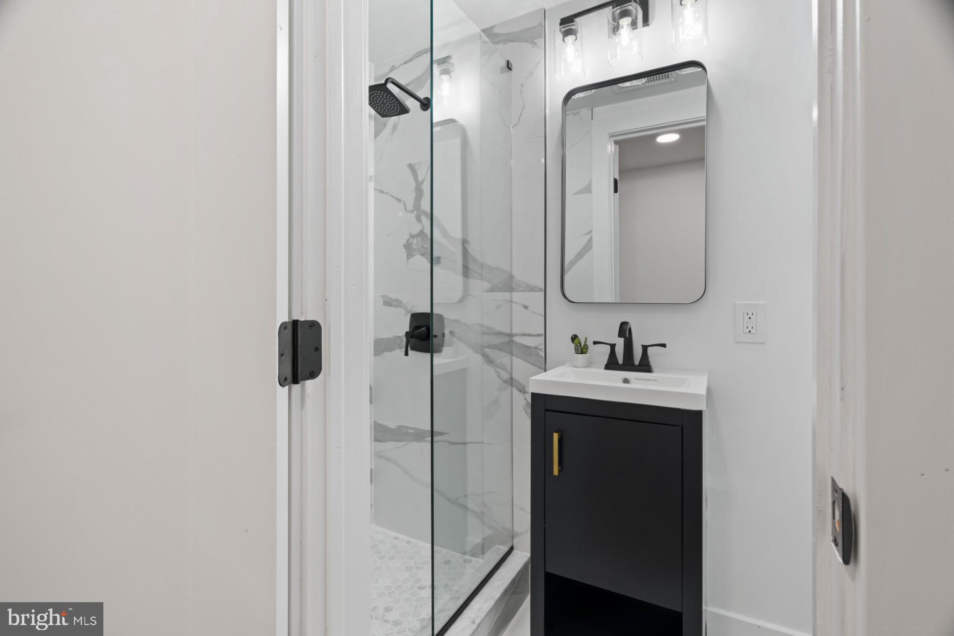 445 Decatur Street Northwest Washington, DC 20011 - Photo 13 of 28 a bathroom with a sink and mirror