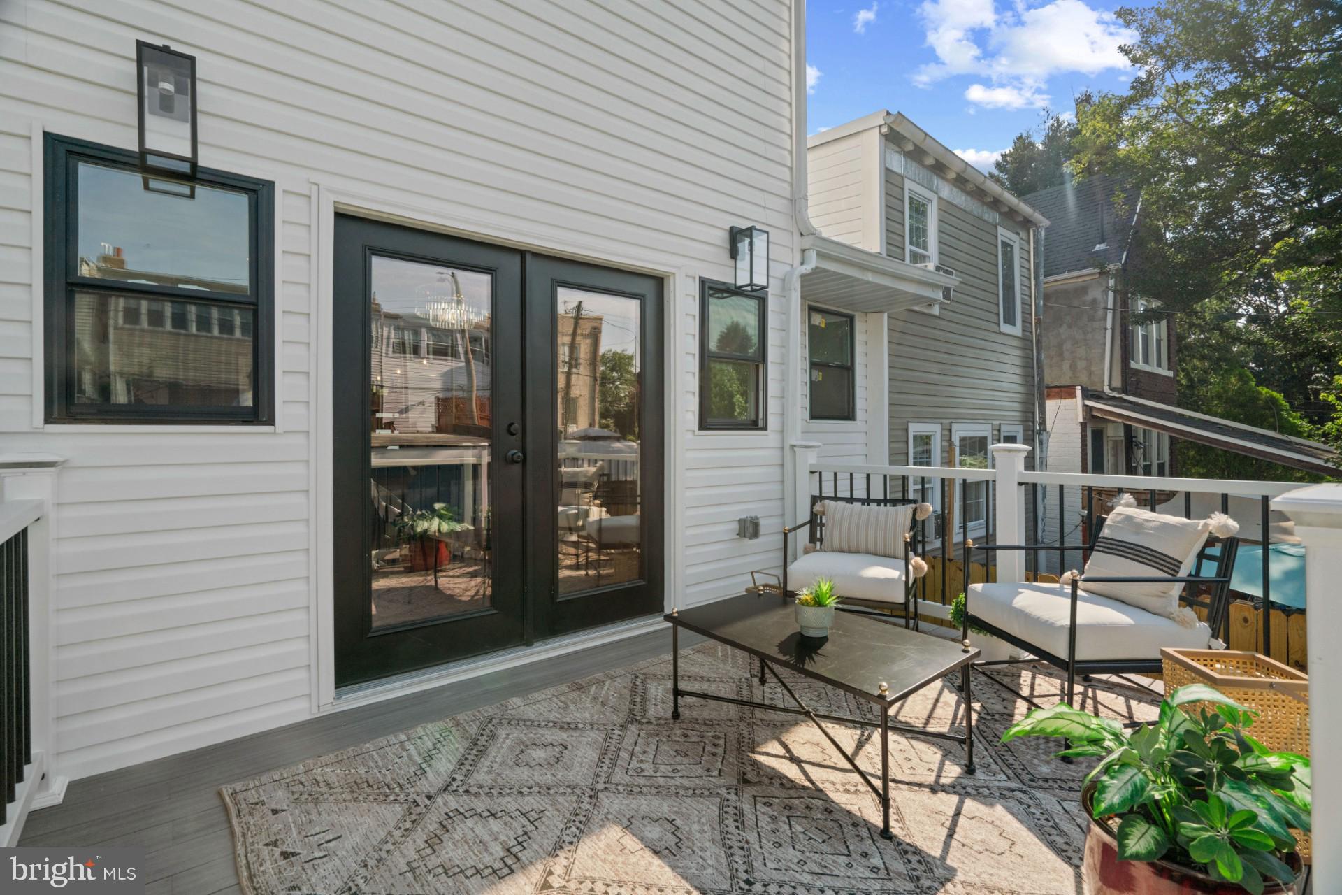 445 Decatur Street Northwest Washington, DC 20011 - Photo 23 of 28 a view of a patio with couple of chairs and a potted plant