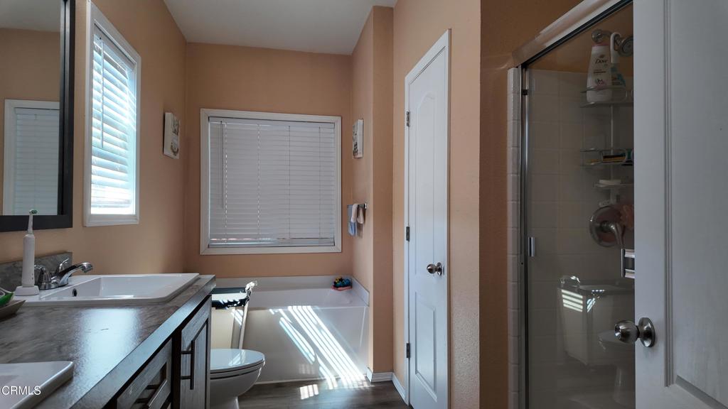 3900 North State Street, Unit 56 Ukiah, CA 95482 - Photo 17 of 29 a bathroom with a granite countertop sink a mirror and a bathtub