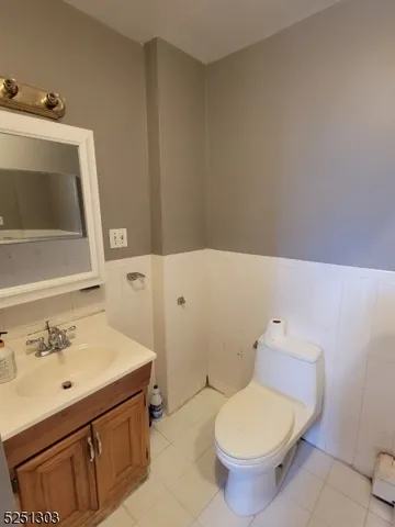a bathroom with a sink toilet and mirror