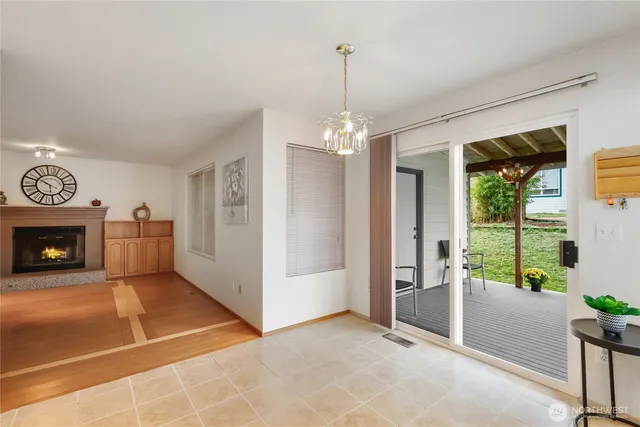 a view of a livingroom with a chandelier a fireplace and a window