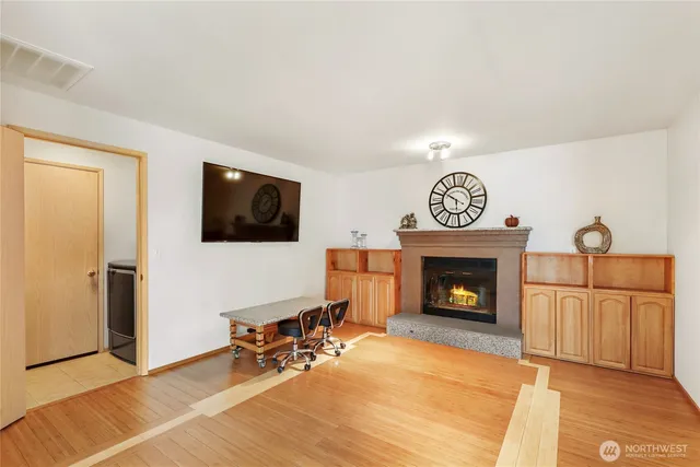 a living room with furniture a fireplace and a flat screen tv