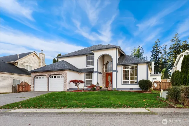 a front view of a house with a garden