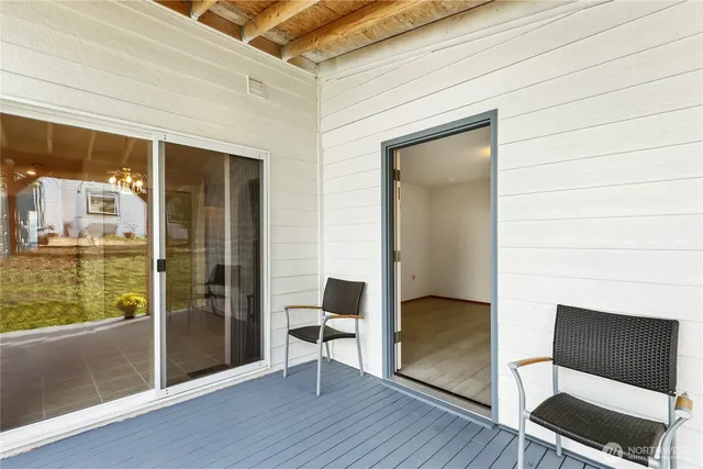 a backyard of a house with table and chairs