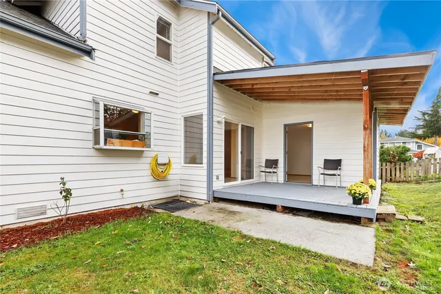 a view of house with outdoor seating area