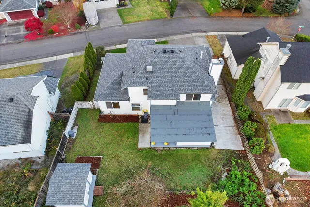 an aerial view of a house with a yard
