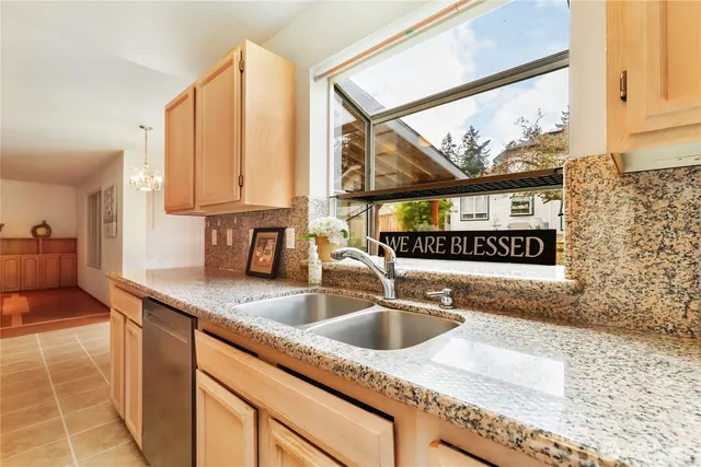a kitchen with kitchen island a sink a counter top space and cabinets