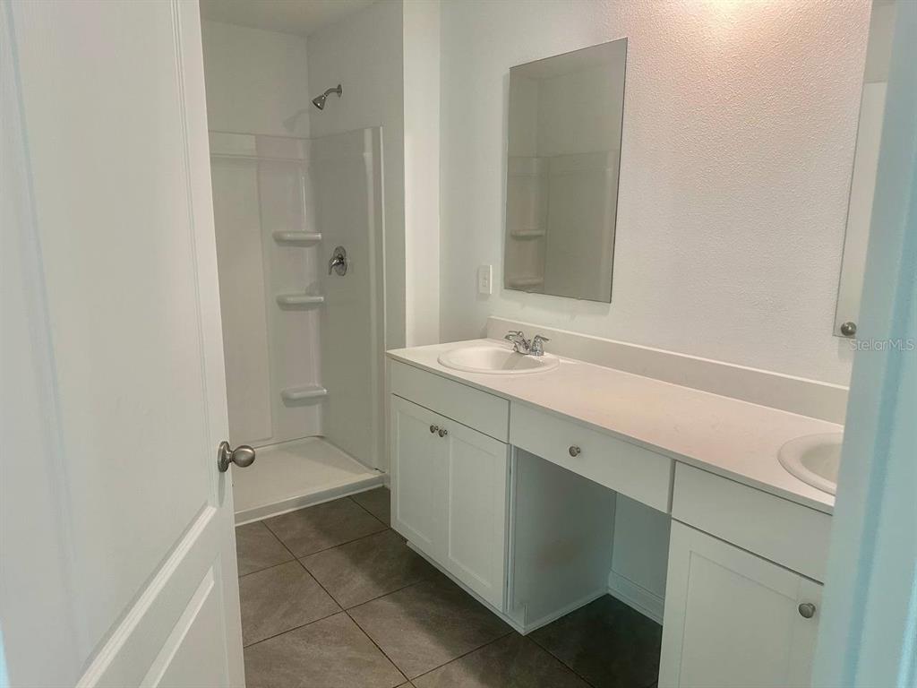 455 Redbud Road Palm Coast, FL 32137 - Photo 3 of 12 a bathroom with a sink a toilet and shower