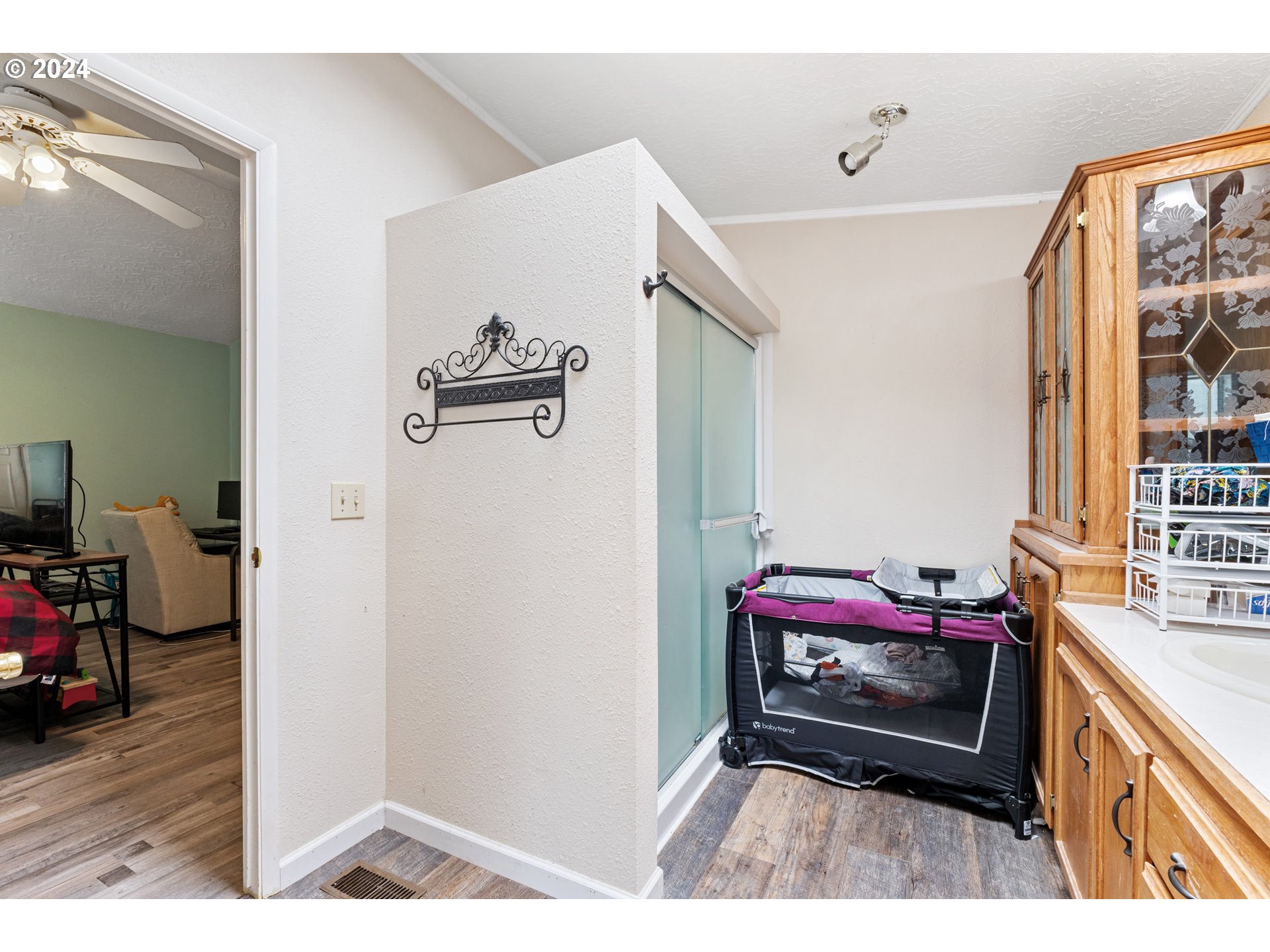 1083 South 59th Street Springfield, OR 97478 - Photo 20 of 29 a hallway with a bed and a couch