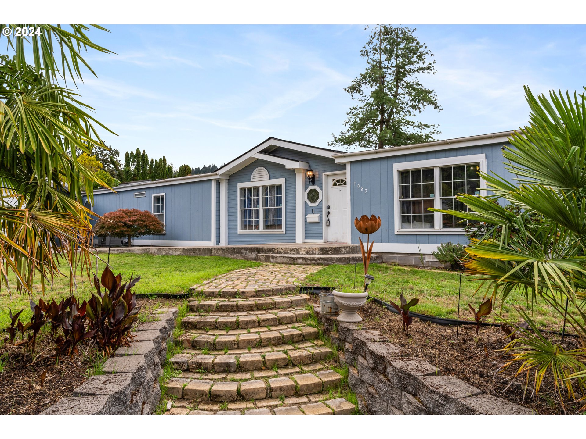 1083 South 59th Street Springfield, OR 97478 - Photo 4 of 29 a front view of a house with garden