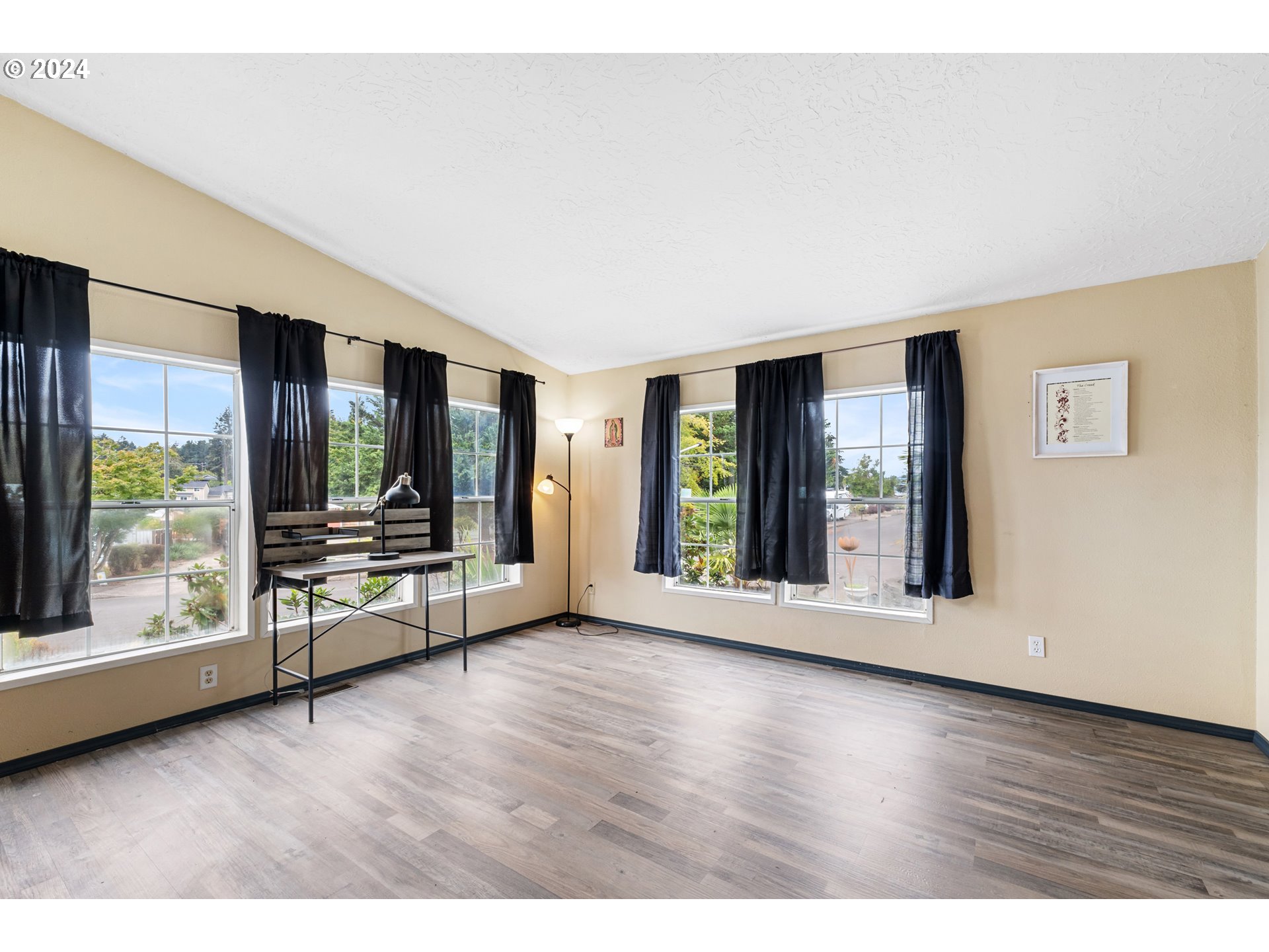 1083 South 59th Street Springfield, OR 97478 - Photo 10 of 29 a view of an empty room with wooden floor and a window