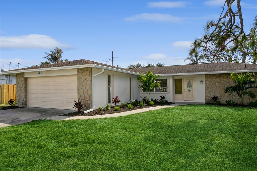 352 Gardenia Road Venice, FL 34293 - Photo 1 of 1 a front view of a house with a garden and yard