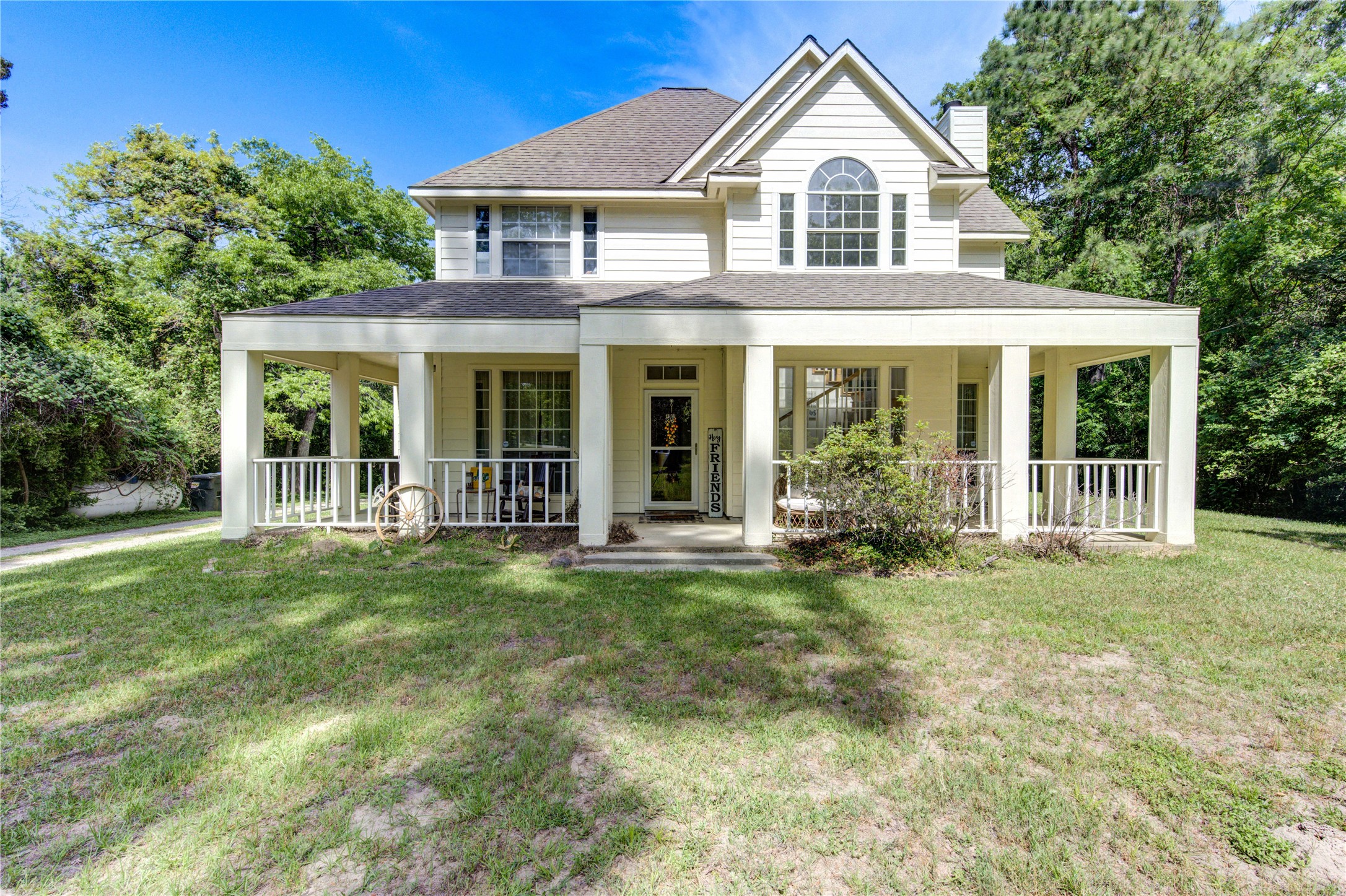 Charming two-story home with a welcoming wrap-around porch, nestled amidst lush greenery. The exterior features large windows and a gable roof, offering plenty of natural light and curb appeal. Ideal for those seeking a serene and picturesque setting.