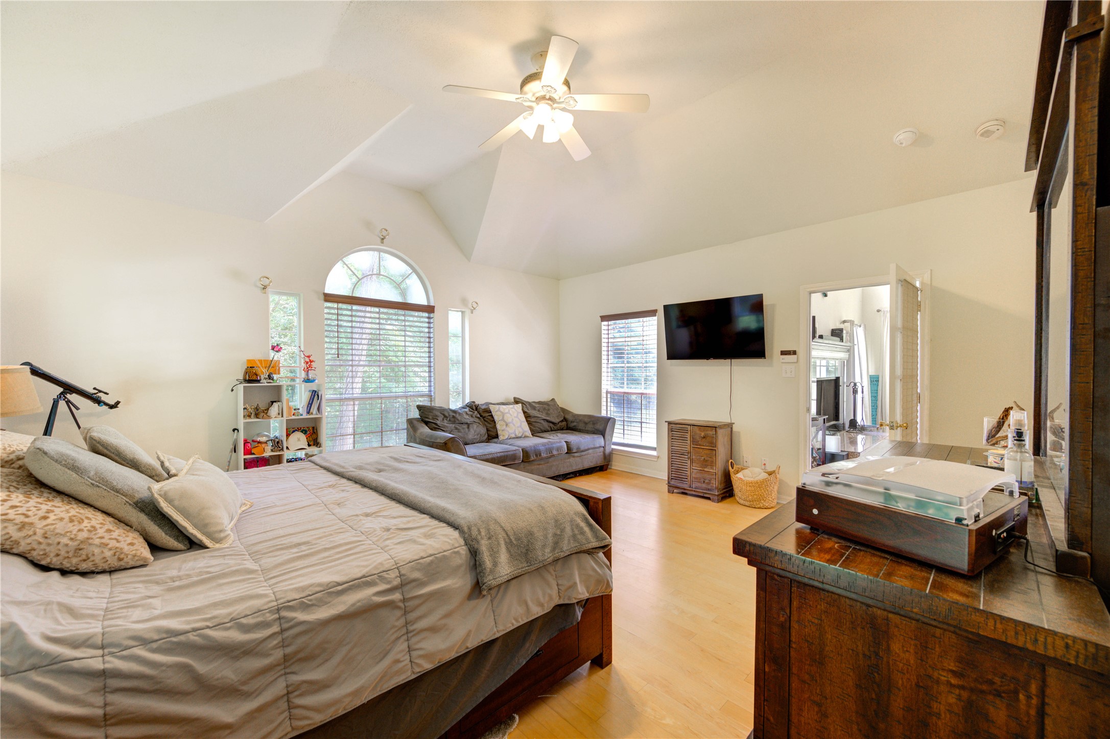 25903 Penguin Street Magnolia, TX 77355 - Photo 12 of 46 a bedroom with bed a flat tv screen and a chandelier