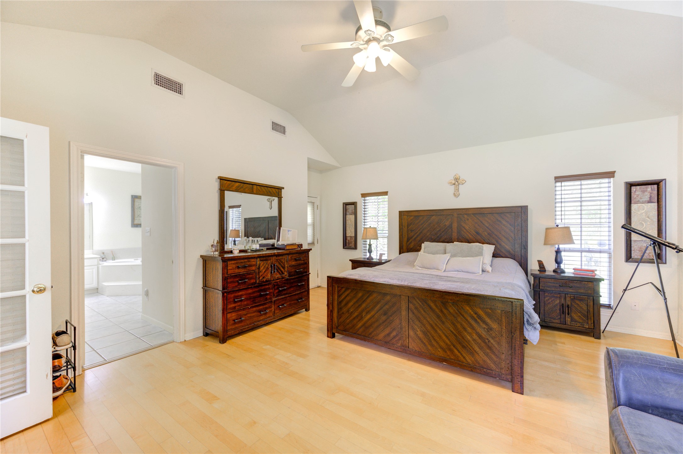 25903 Penguin Street Magnolia, TX 77355 - Photo 14 of 46 a bedroom with a large bed and a chandelier