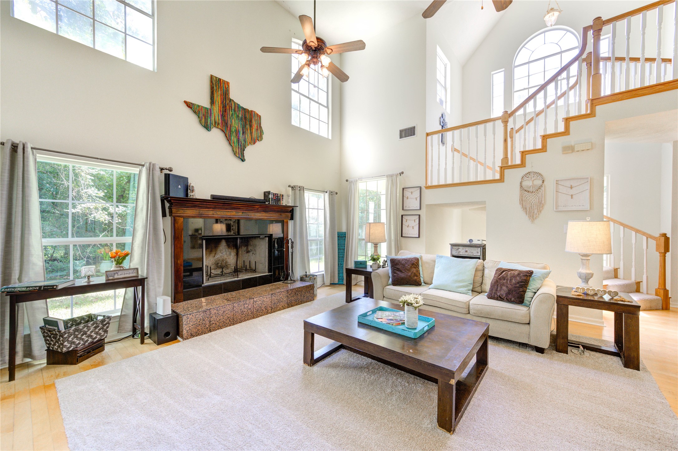 25903 Penguin Street Magnolia, TX 77355 - Photo 26 of 46 a living room with furniture a fireplace and a floor to ceiling window