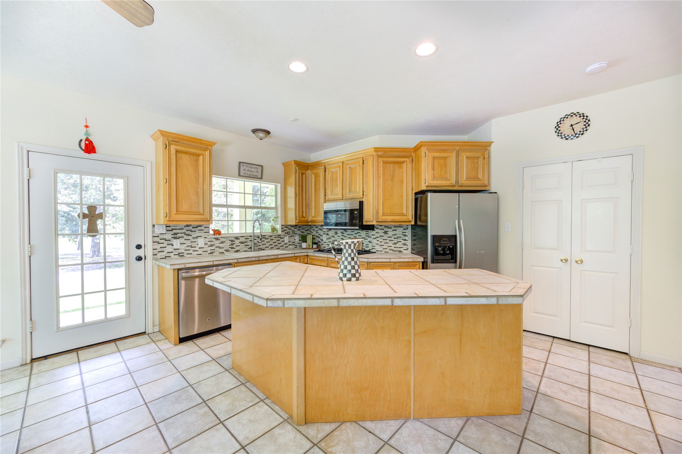 25903 Penguin Street Magnolia, TX 77355 - Photo 39 of 46 a kitchen with stainless steel appliances granite countertop a sink and a refrigerator
