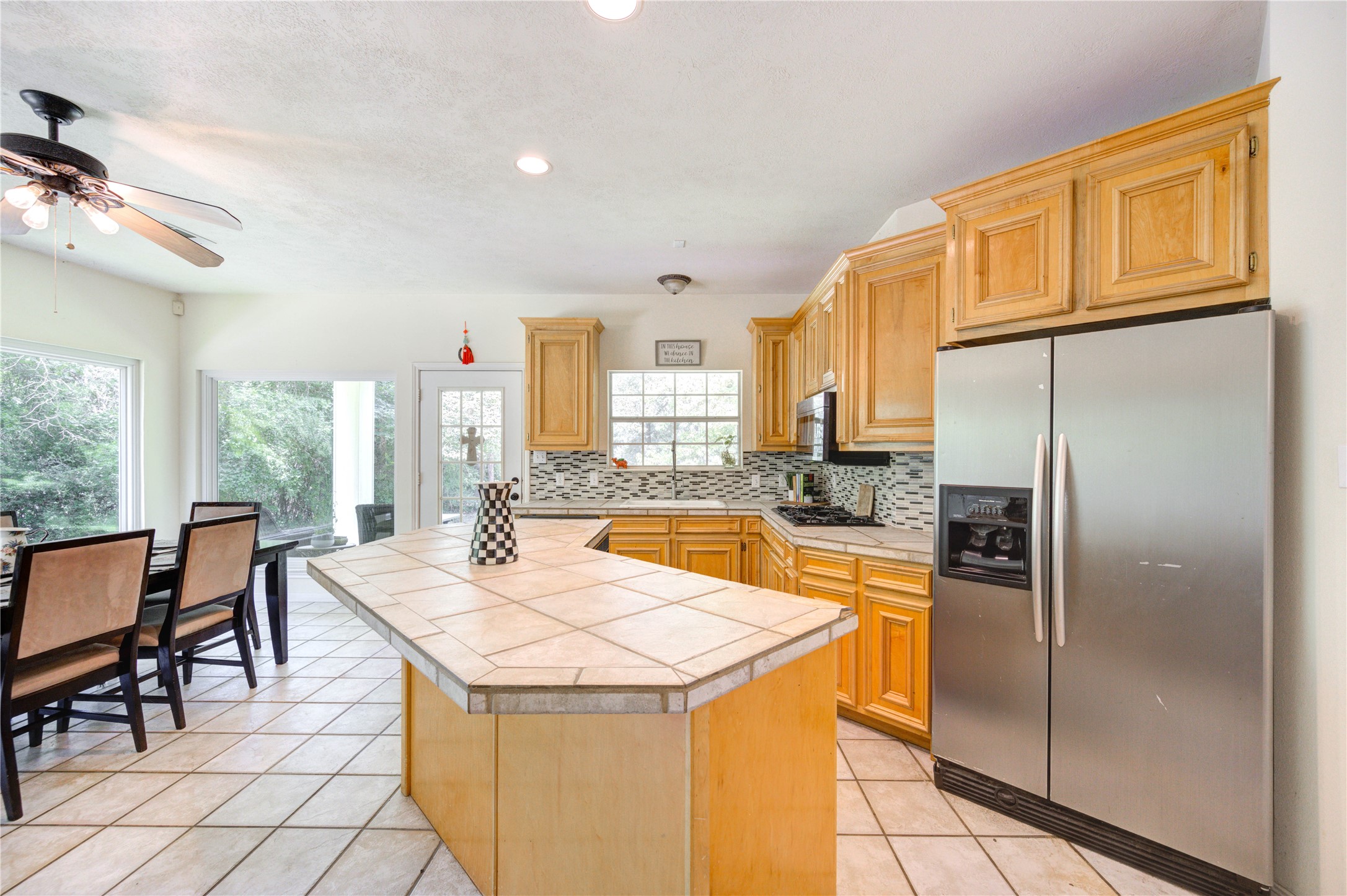 25903 Penguin Street Magnolia, TX 77355 - Photo 42 of 46 a kitchen with stainless steel appliances granite countertop a refrigerator a sink a stove and island