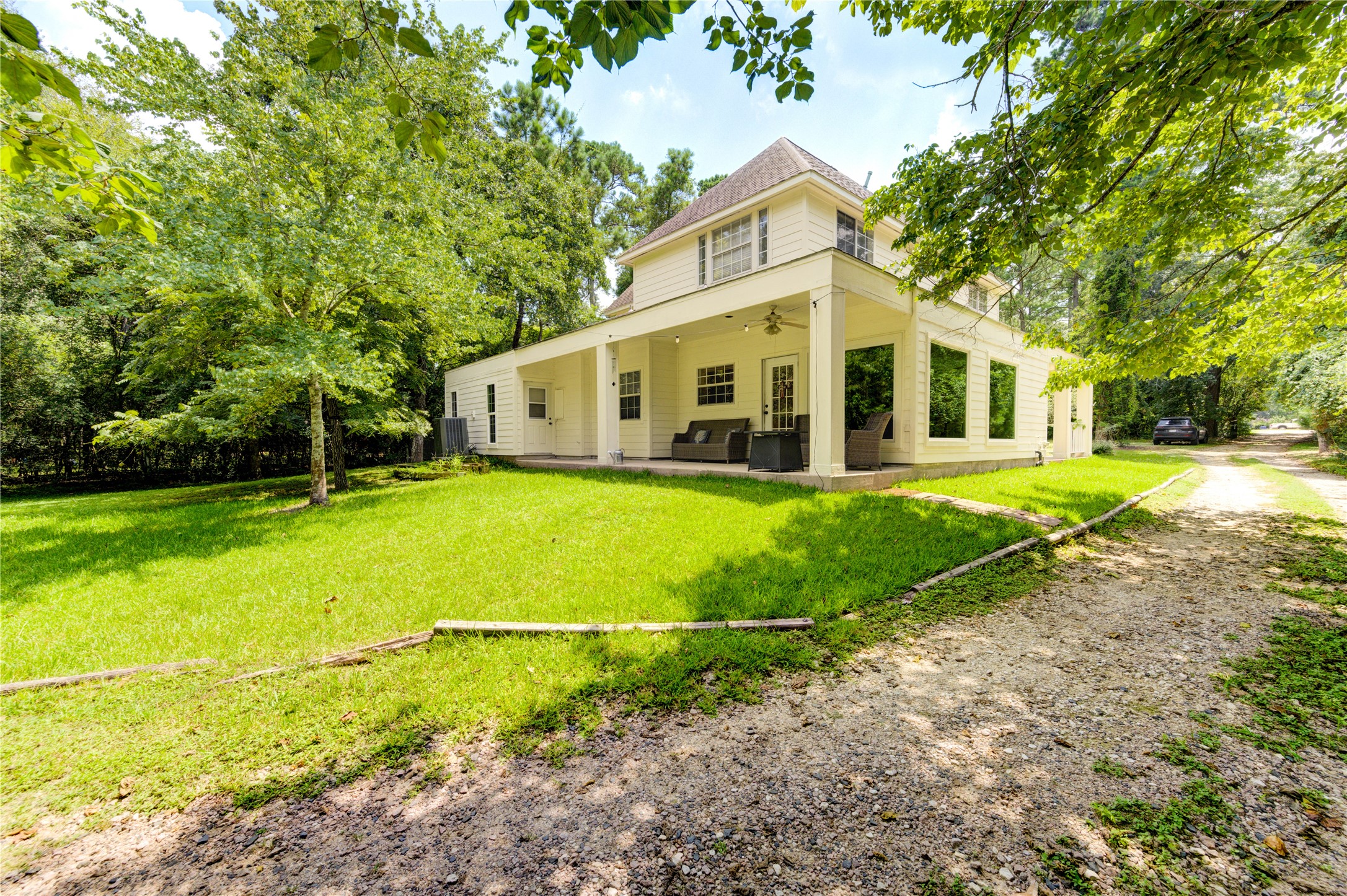 25903 Penguin Street Magnolia, TX 77355 - Photo 45 of 46 a view of a white house with a big yard and potted plants and large trees