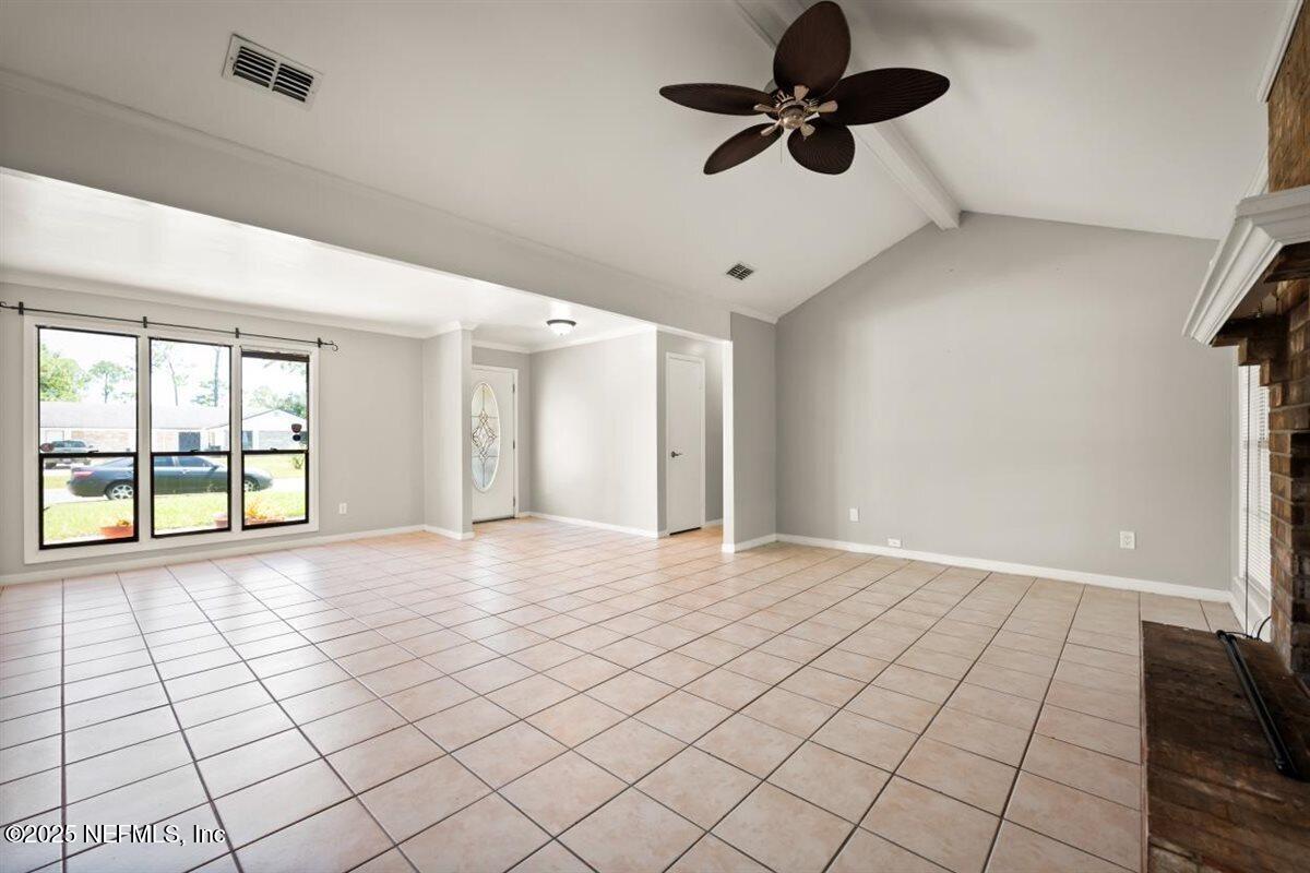 2477 Ridgecrest Avenue Orange Park, FL 32065 - Photo 12 of 28 a view of an empty room and window with a chandelier fan