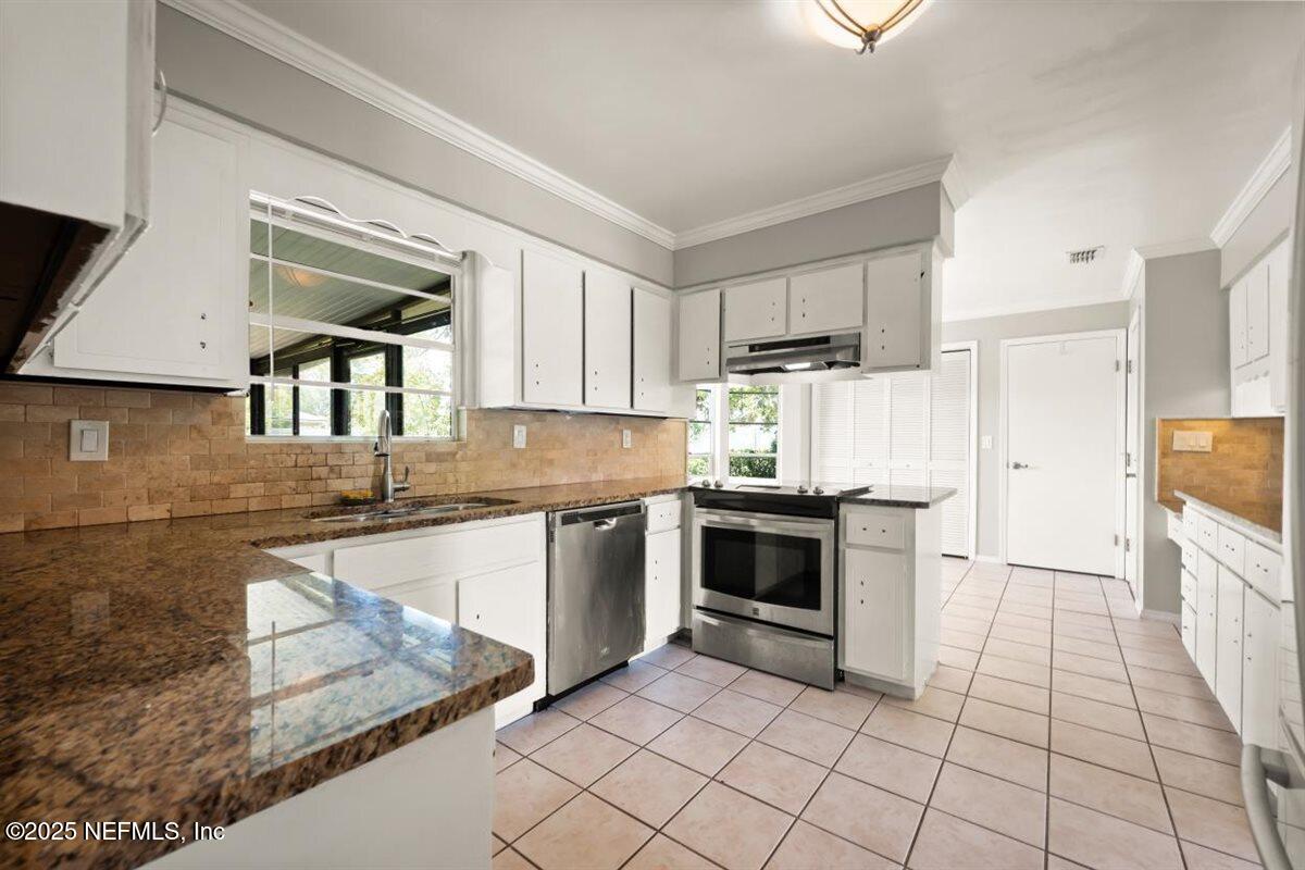 2477 Ridgecrest Avenue Orange Park, FL 32065 - Photo 14 of 28 a kitchen with stainless steel appliances granite countertop a stove a sink and a microwave