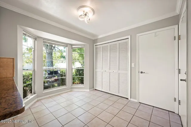 a bedroom with a large bed and a large window