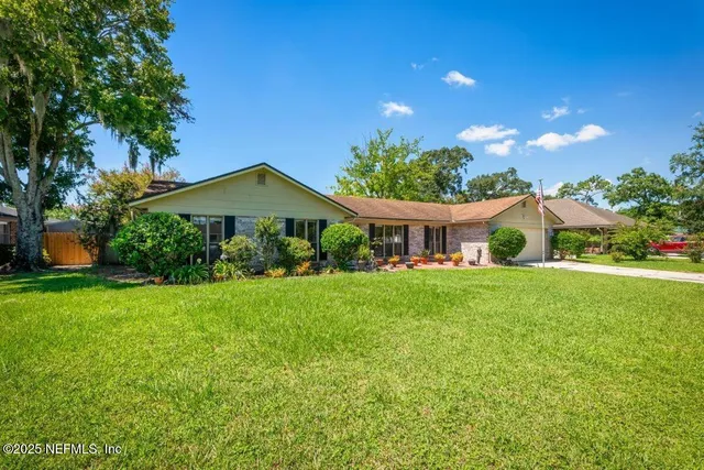 a front view of house with yard and green space
